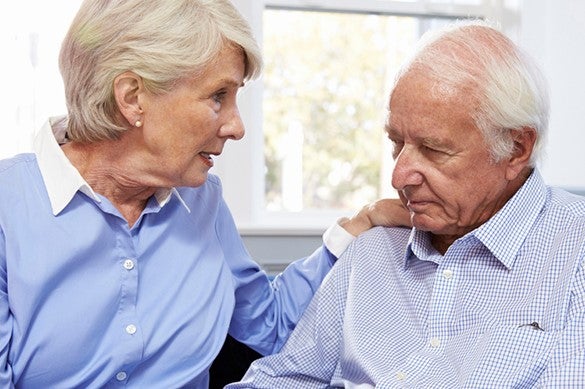 elderly-woman-comforting-elderly-man